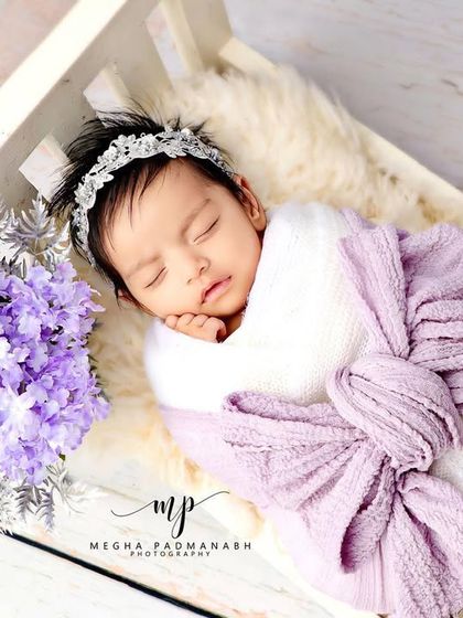 A wider view of the purple and white bed setup.