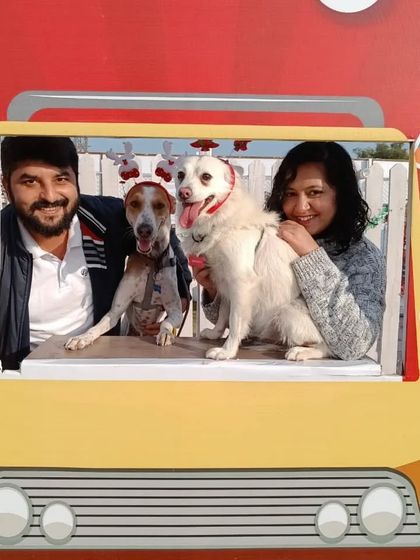 This family, complete with festive reindeer antlers on their dog, captures a perfect holiday memory at our Christmas event.