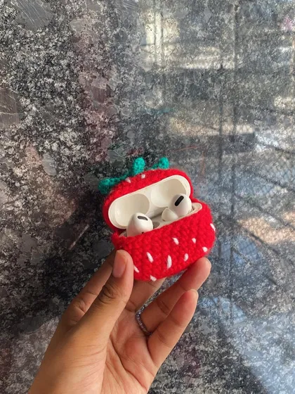 Protect your tech with a touch of handmade cuteness. This is a custom-made crochet strawberry case designed to perfectly fit AirPods.