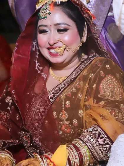 The joy on a bride's face is the best reward. This candid shot captures her radiant smile, enhanced by a glowing, flawless makeup look.