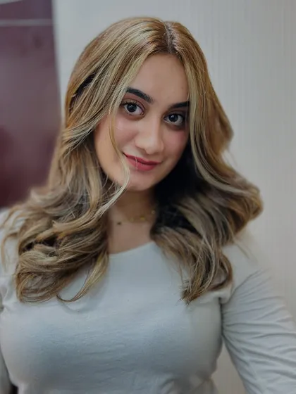 A beautiful portrait of our client with her new ash blonde hair. The face framing pieces brighten her complexion perfectly.