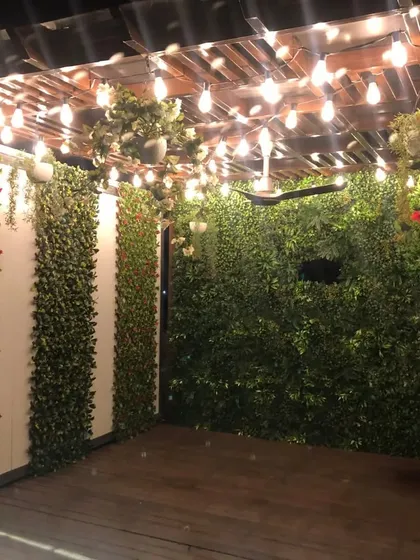 Another view of the pergola project in Dilshad Garden. I used vertical strips of foliage on the walls and hanging floral arrangements to create a layered, immersive garden experience.
