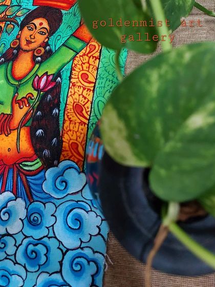 A close-up of the Flower Girl painting, peeking from behind a money plant. Art and nature go so well together.