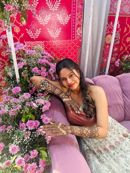 Another lovely shot of the client enjoying the beautiful decor and her intricate henna art.