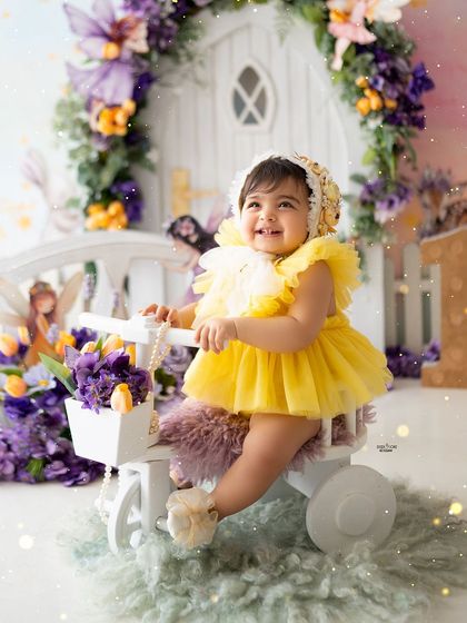 A magical first birthday in a Rapunzel-inspired enchanted forest, with yellow and purple flowers.