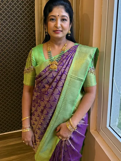 Our gorgeous client Pratima looks absolutely radiant in this designer Kanjivaram silk saree. The breathtaking combination of purple and light green is a true masterpiece, perfect for weddings and festive celebrations where you want to embrace luxury and heritage.
