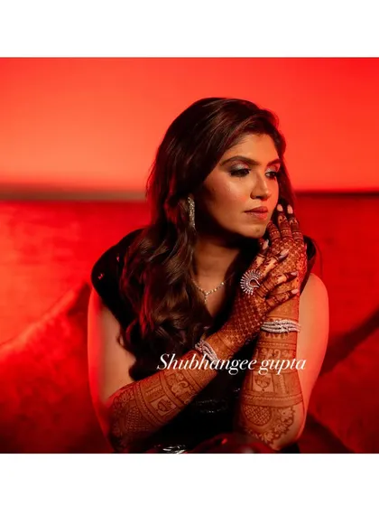 A stunning professional photograph capturing the beauty of the final henna stain. The rich color adds so much elegance to the bride's overall look.