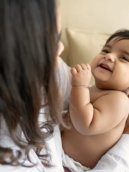 Mother love. A close-up of a mother's face as she holds her baby, full of tenderness and affection.
