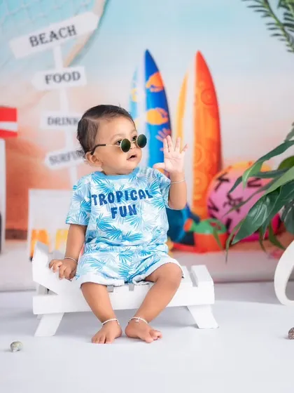 This cool little guy is ready for some tropical fun. Our beach theme is perfect for first birthday milestones, complete with fun outfits and a relaxed vibe.