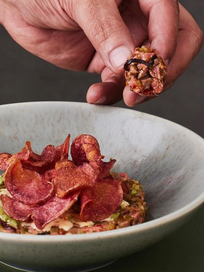 Another angle of the Seared Steak Tartare, showing the texture of the hand-chopped steak and the crispiness of the chips.