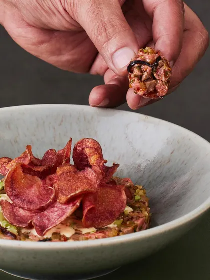 Another angle of the Seared Steak Tartare, showing the texture of the hand-chopped steak and the crispiness of the chips.