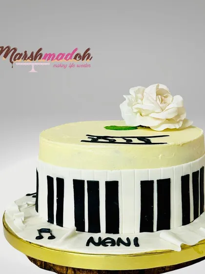 A beautiful cake for a mother who loves music, especially the piano. This Classic Chocolate Truffle cake is decorated with fondant piano keys and a delicate, handmade sugar rose.