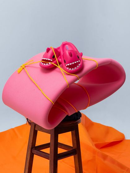 Another angle of our conceptual shoot for the kids' clogs, showing the entire setup with the stool and colorful fabrics.