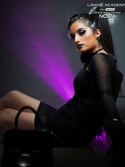 A full-length shot showing the complete edgy look, from the high ponytail to the all-black outfit.