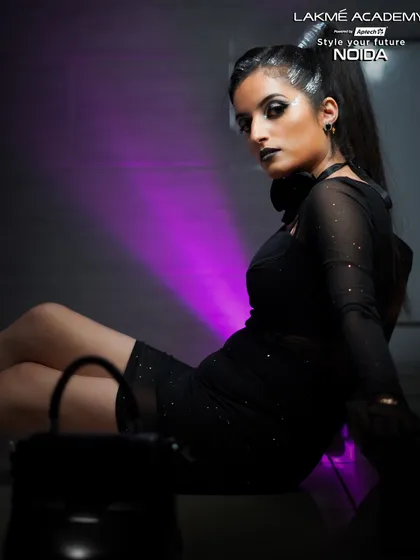 A dramatic pose with a modern glam look. The purple backlighting adds to the mood, showcasing how to use lighting to create impactful photos.