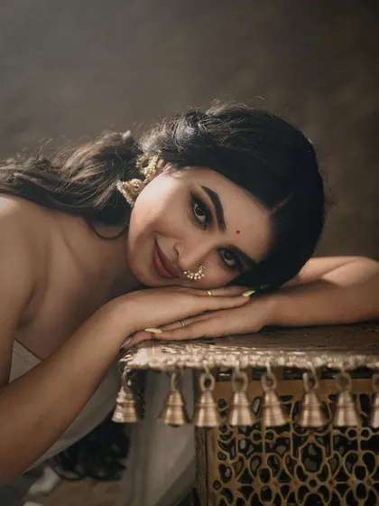 A soft and emotive portrait capturing a timeless, divine beauty. The model's gentle expression and the warm, painterly lighting create a fine-art feel, perfect for classic and traditional photoshoots that require a touch of grace.