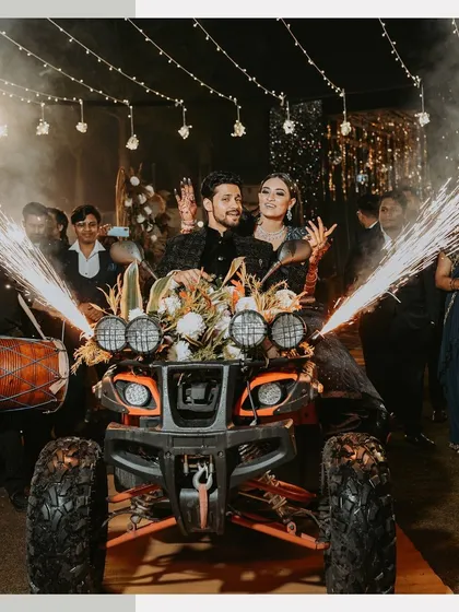 Making an unforgettable entrance on an ATV. This shot captures the couple's bold and fun personality during their Sangeet night, complete with dhol players and sparklers.
