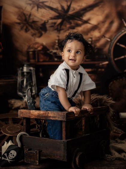 A candid moment of exploration as the little one climbs out of his wooden crate, full of curiosity.