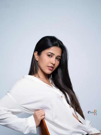 A seated portrait in the white shirt, creating a relaxed and approachable vibe.