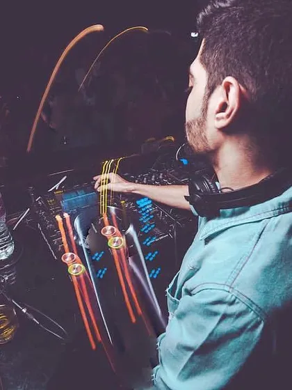 An overhead shot of me working the faders on the console, with light streaks adding to the dynamic feel of a live set.
