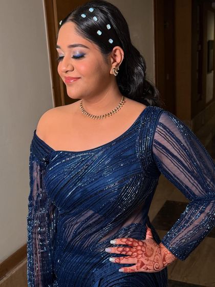 A close-up showing the detail of the blue eyeshadow. The shimmer adds a touch of glamour, while the clean base and soft lip keep the look sophisticated and not overdone.