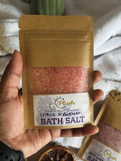 Holding a packet of my Citrus & Rosemary bath salt. The natural ingredients make for a truly aromatic and therapeutic soak.