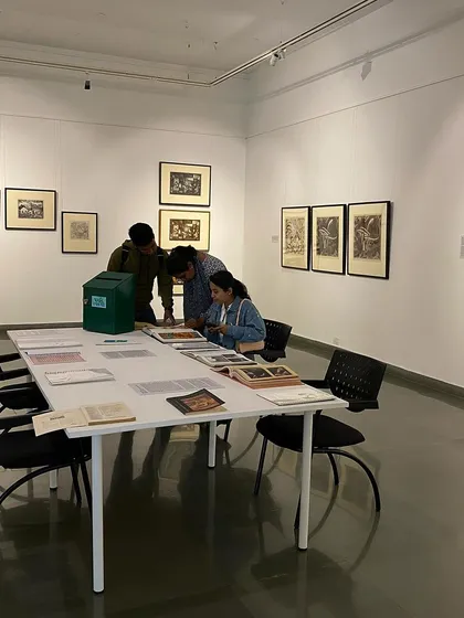 A group of young visitors exploring the books and archival materials.