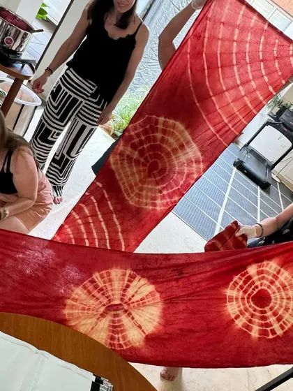 The big reveal! Participants unfurl their organic cotton stoles to see the beautiful, intricate patterns they created. The excitement in this moment is always palpable.