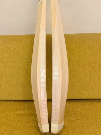 The side profile of the bats, showing the thickness of the edges and the shape of the spine. This profile is crucial for a bat's balance and power.