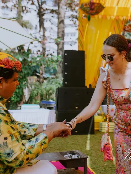 A guest getting her fortune told at the Haldi mela. These small, interactive details are what elevate a wedding from a party to a truly memorable experience.
