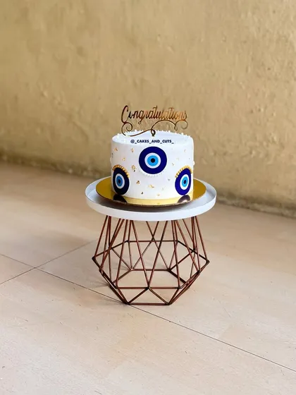 A "Congratulations" cake with an evil eye theme, perfect for warding off bad vibes and celebrating a new achievement.