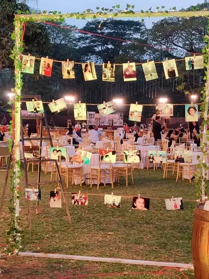 We love creating personalized corners like this photo display. We hung the couple's pictures on strings between a rustic frame, flanked by wooden barrels, allowing guests to take a walk down memory lane.
