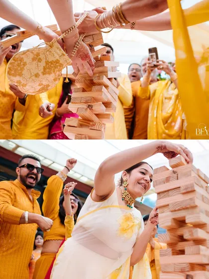 Guests get competitive and have fun with a giant Jenga game during the Haldi celebration.