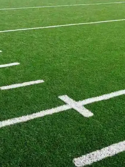 A close-up of the crisp, white yard lines on our football turf. Unlike painted lines on natural grass, these are permanently integrated for a clean look that never fades or needs re-marking.