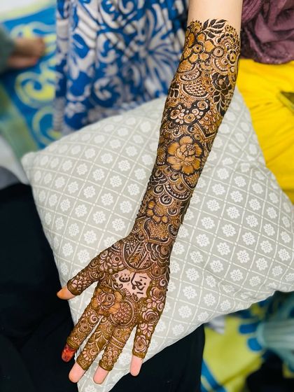 A full-arm view of a stunning bridal floral design. The patterns are dense and the coverage is flawless.