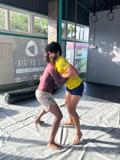 Engaged in a clinch during a grappling session. This is about using leverage and strength to control your opponent.