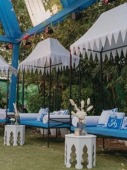 Custom-designed cabanas with block-printed cushions and unique 'jharokha' style side tables. This seating area provided a comfortable and shaded spot for guests to enjoy the Haldi festivities.