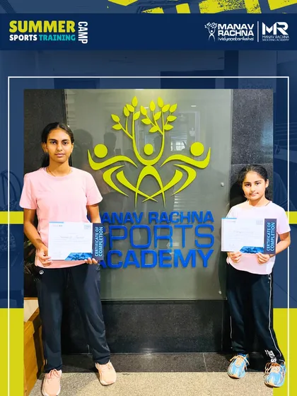 Two participants proudly display their certificates of completion at the end of the Summer Sports Training Camp. We celebrate the hard work and progress of every student who joins our program.