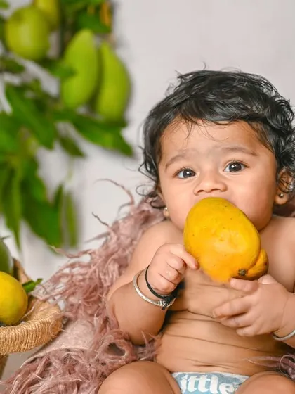 This little one is enjoying a mango during our seasonal fruit-themed shoot.