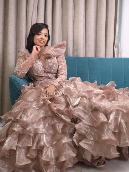 A moment of quiet elegance. This client looks stunning in a high-fashion ruffled gown, perfect for making a statement at a reception.