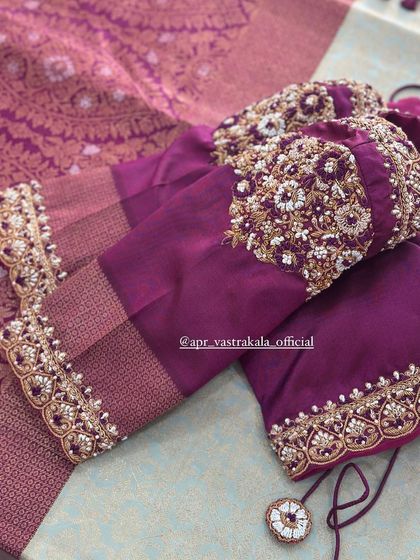 A purple blouse with heavily embroidered cuffs.