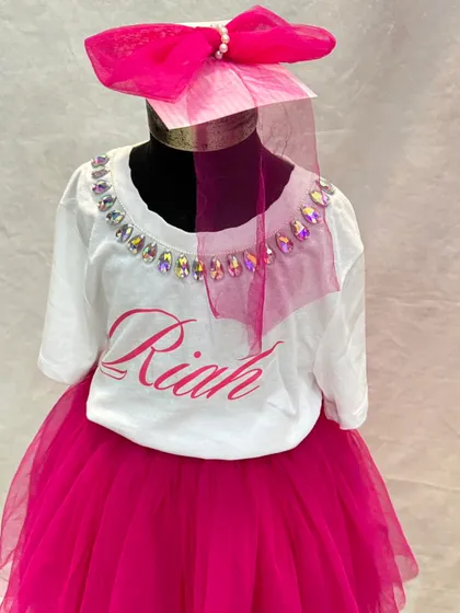 A closer look at our personalized birthday t-shirt, featuring the birthday girl's name and a crystal-embellished neckline. It's the perfect top to pair with a fun tulle skirt.