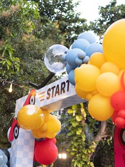 The "Start" line for the race car party, marked by a custom sign and colorful balloons.