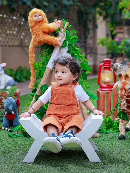 A little boy sits peacefully in a lush garden, surrounded by his favorite stuffed animals. Outdoor shoots allow for a natural and relaxed atmosphere.
