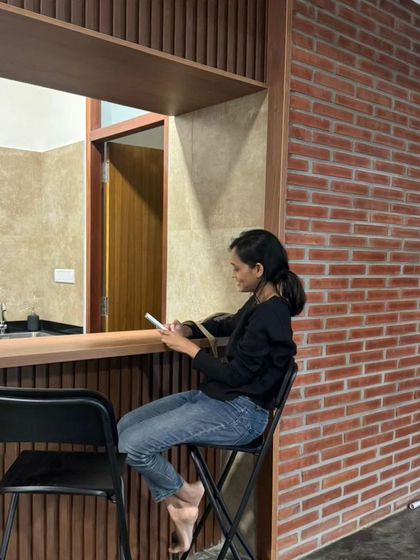 A pantry and bar counter at the Samagataorg office. The clean lines, wood paneling, and exposed brick wall demonstrate how we apply our material palette to modern commercial interiors.