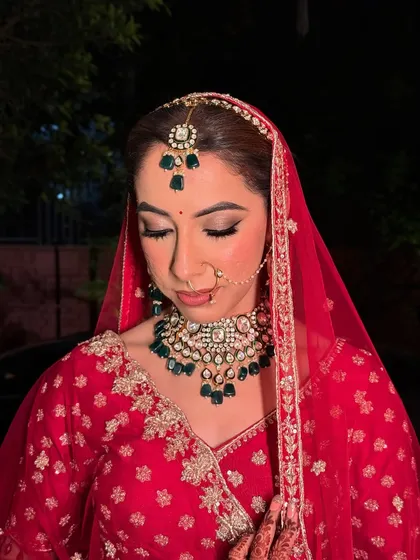 Kritika, looking stunning for her pheras. The soft glam eye makeup and flawless airbrush base complement her traditional red attire perfectly.
