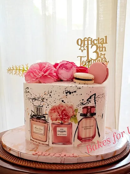 "Official 13th Teenager." A chic cake for a new teen, featuring edible prints of designer perfume bottles like Chanel and Dior, topped with fresh flowers and macarons.