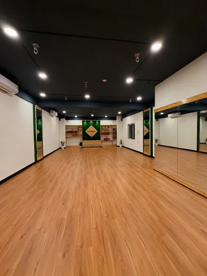 This is our sanctuary. A wide, sunlit space with everything you need to focus on your practice, from full-length mirrors for alignment to a warm, welcoming atmosphere.