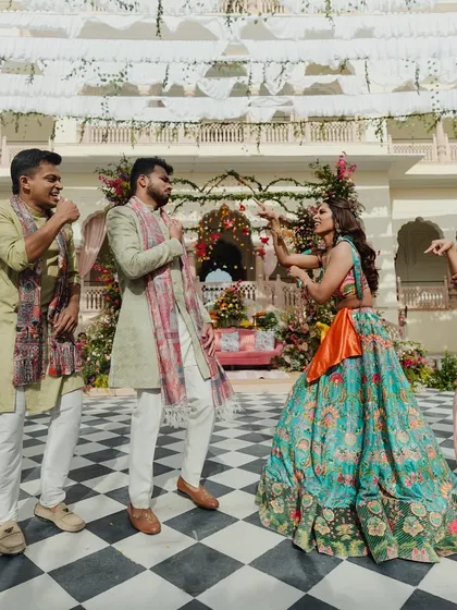 A playful moment during a Mehendi, where the groom's and bride's squads have a friendly dance-off.