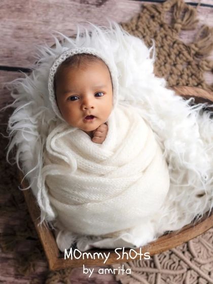 A final portrait showcasing a newborn in a heart-shaped bowl, demonstrating a classic and beloved prop setup.